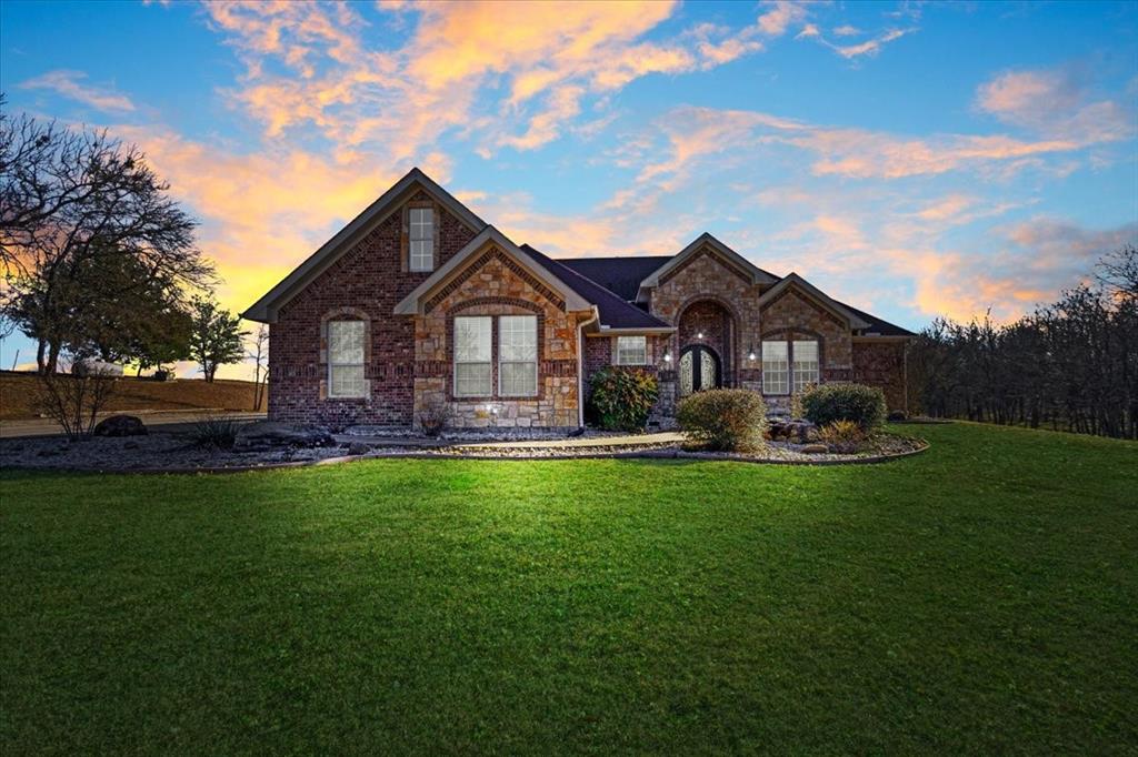 a front view of a house with a garden