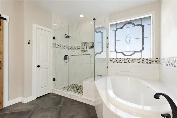 a spacious bathroom with a double vanity sink mirror and bathtub