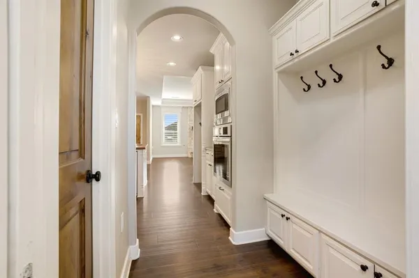a view of a room with wooden floor and white walls