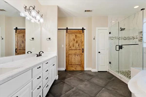 a bathroom with a bathtub and a shower