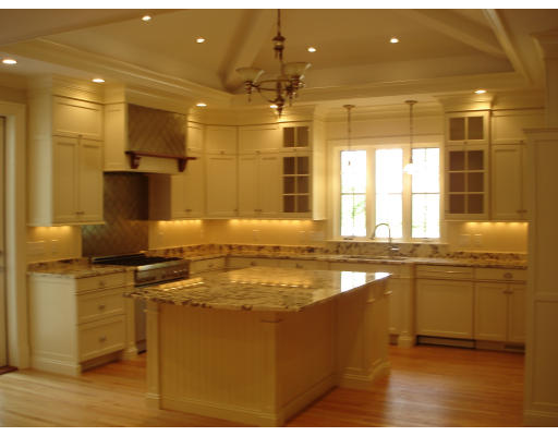 65 Denton Road Wellesley, MA 02482 - Photo 7 of 11 a kitchen with stainless steel appliances granite countertop a sink stove and cabinets
