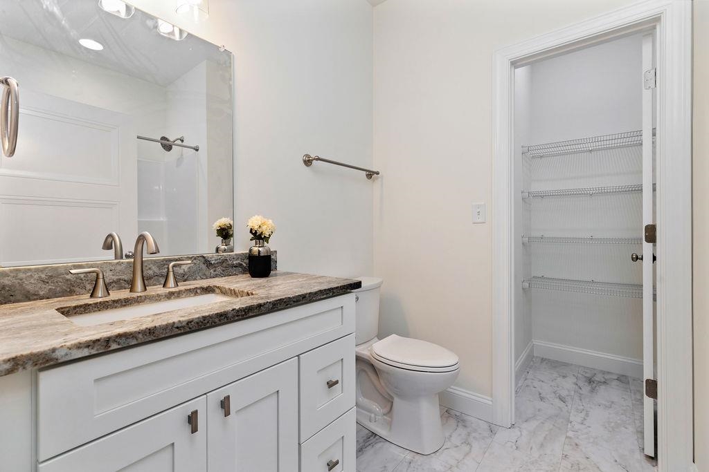 833 Faber Avenue Waynesboro, VA 22980 - Photo 26 of 36 a bathroom with a granite countertop sink a toilet and a mirror