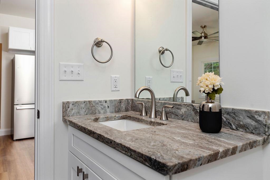 833 Faber Avenue Waynesboro, VA 22980 - Photo 27 of 36 a bathroom with a granite countertop sink a mirror and shower