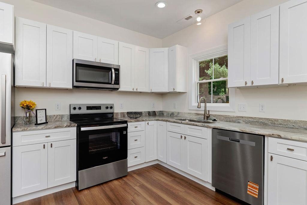 833 Faber Avenue Waynesboro, VA 22980 - Photo 5 of 36 a kitchen with granite countertop white cabinets and stainless steel appliances