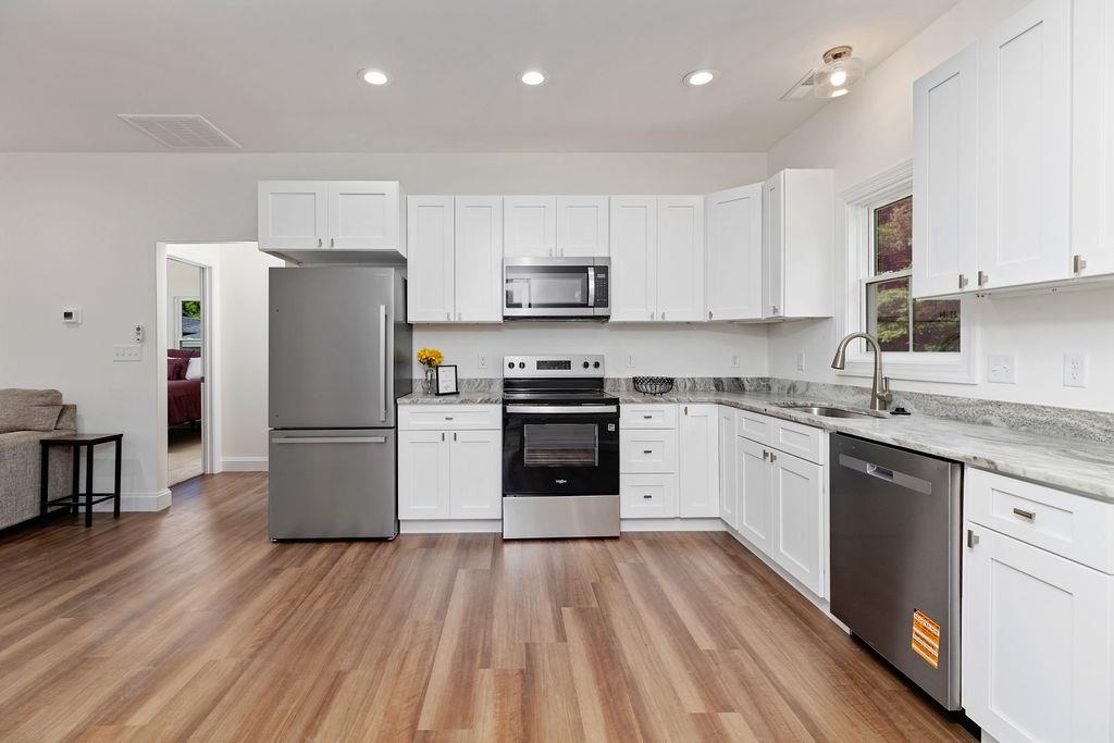 833 Faber Avenue Waynesboro, VA 22980 - Photo 6 of 36 a kitchen with a refrigerator a stove top oven and white cabinets