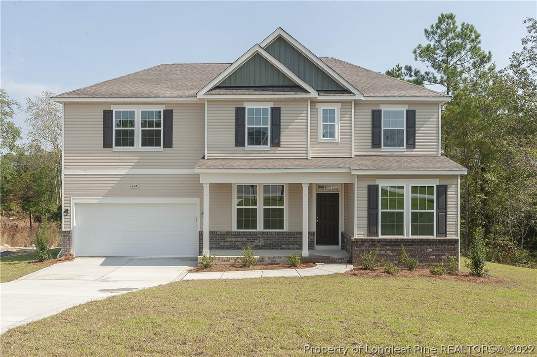 454 Pittfield Run Cameron, NC 28326 - Photo 1 of 37 a front view of a house with a yard and garage