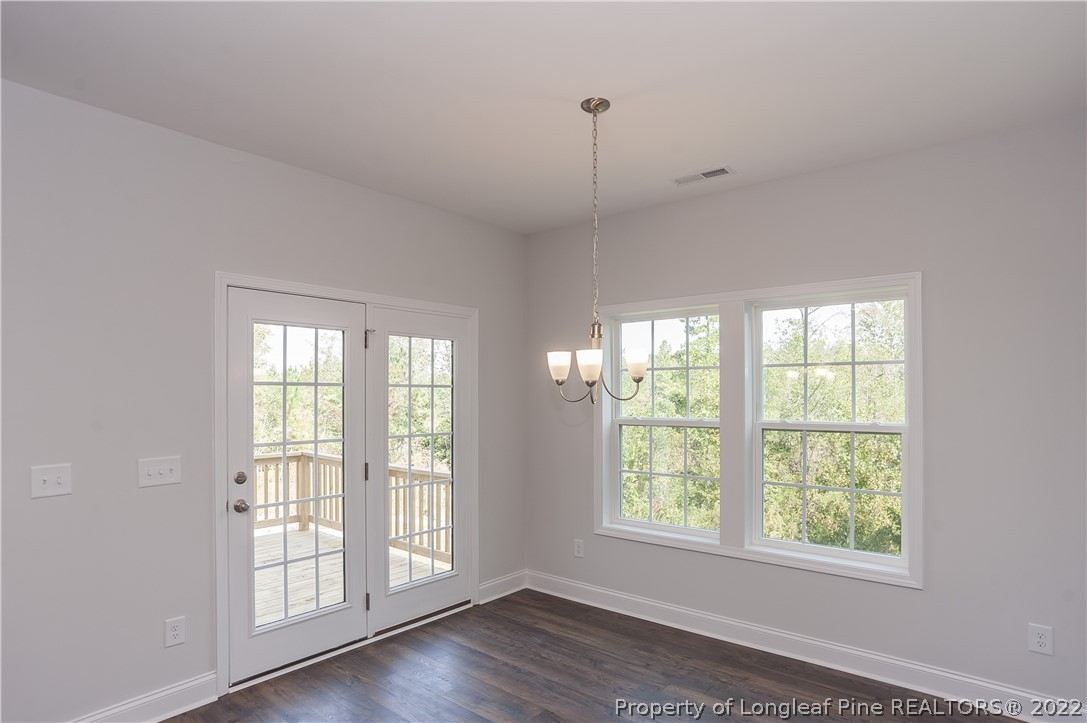 454 Pittfield Run Cameron, NC 28326 - Photo 12 of 37 a view of an empty room with wooden floor and a window
