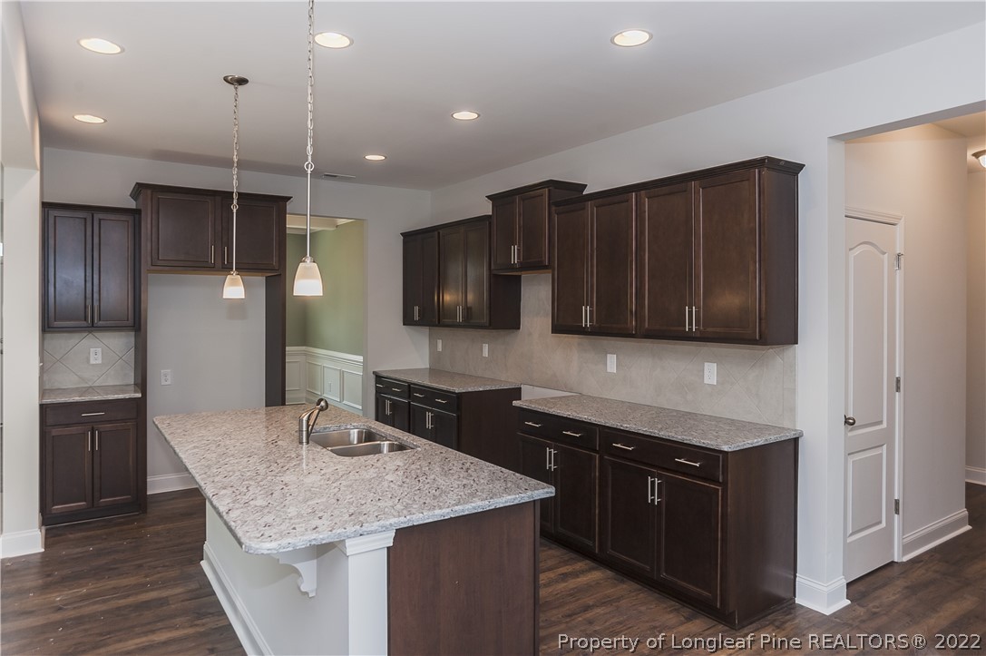 454 Pittfield Run Cameron, NC 28326 - Photo 13 of 37 a kitchen with stainless steel appliances granite countertop a sink dishwasher stove and refrigerator with wooden floor
