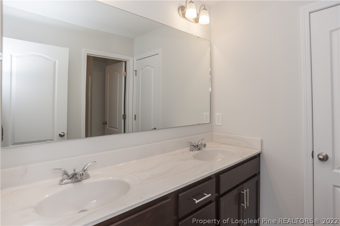 454 Pittfield Run Cameron, NC 28326 - Photo 27 of 37 a bathroom with a sink vanity and a mirror