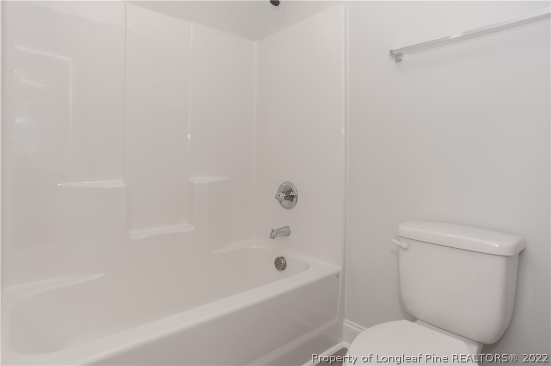 454 Pittfield Run Cameron, NC 28326 - Photo 28 of 37 a bathroom with a toilet and a bathtub