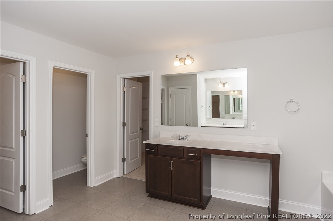 454 Pittfield Run Cameron, NC 28326 - Photo 34 of 37 a bathroom with a sink and a mirror