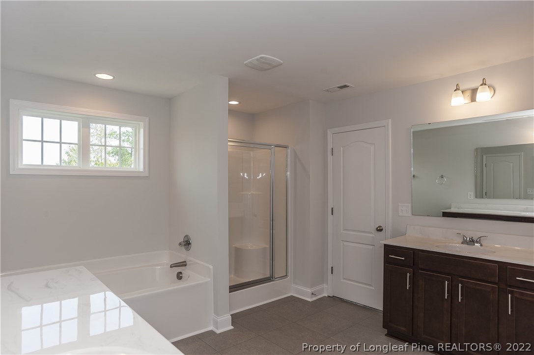 454 Pittfield Run Cameron, NC 28326 - Photo 37 of 37 a spacious bathroom with a tub sink shower and mirror