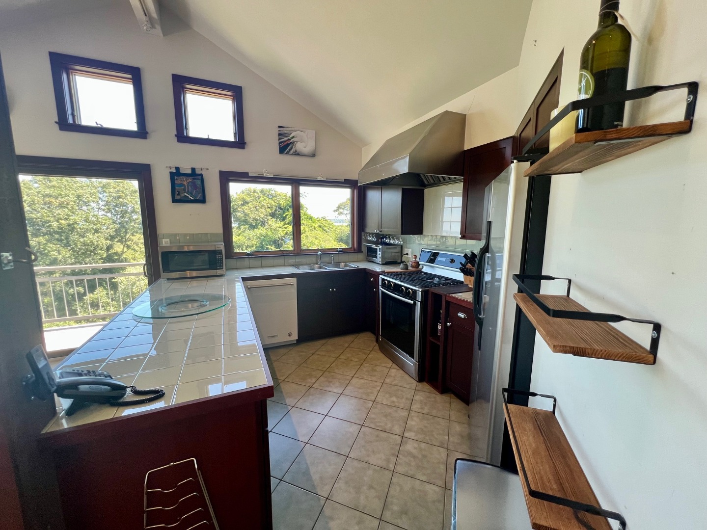 382 Lighthouse Road Aquinnah, MA 02535 - Photo 11 of 29 a kitchen with stainless steel appliances granite countertop a sink stove and refrigerator