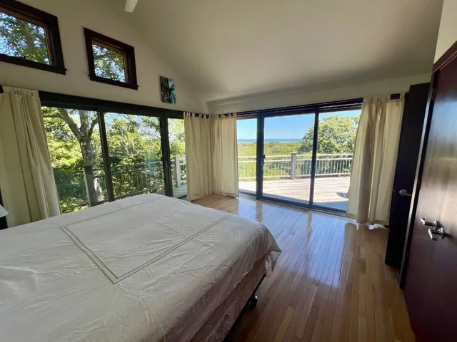 a bedroom with a large bed and a large window