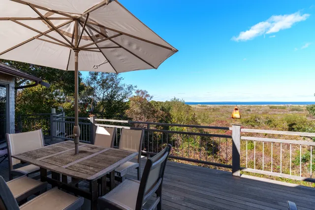 a view of a balcony with furniture and wooden floor