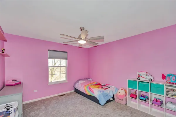 a bathroom with a sink a toilet a mirror and a window