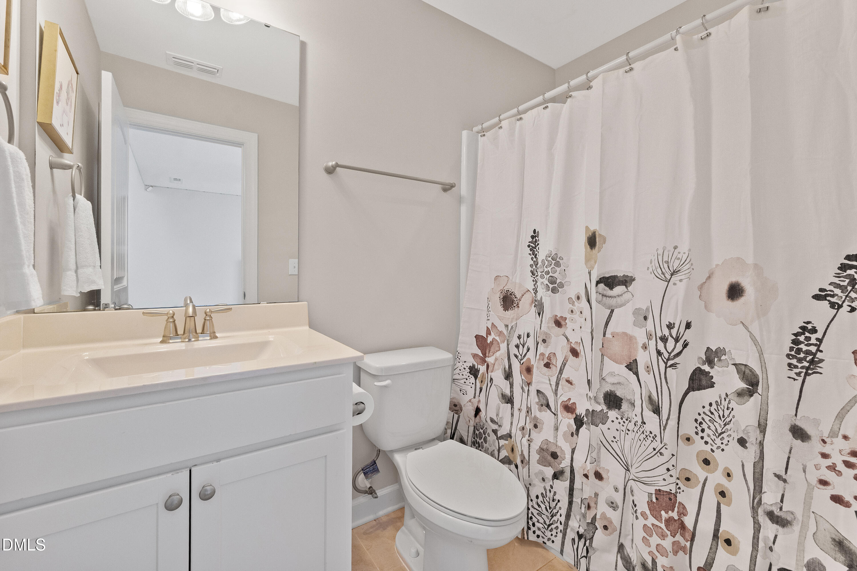 8059 Gilano Drive Raleigh, NC 27603 - Photo 35 of 43 a bathroom with a toilet sink and mirror