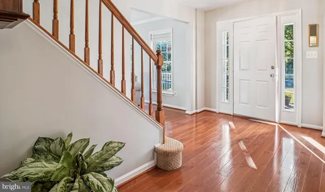 a kitchen with stainless steel appliances granite countertop a refrigerator a stove and a wooden floors