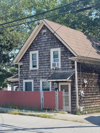 a front view of a house with a garden and garage
