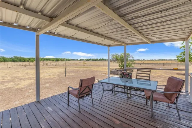 a view of a balcony with chair and wooden floor