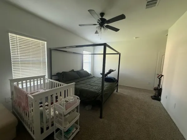 a bedroom with a bed and a mirror