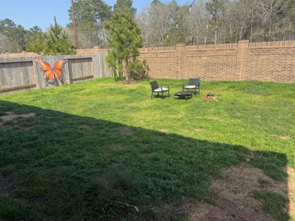 a view of a house with backyard sitting area and garden