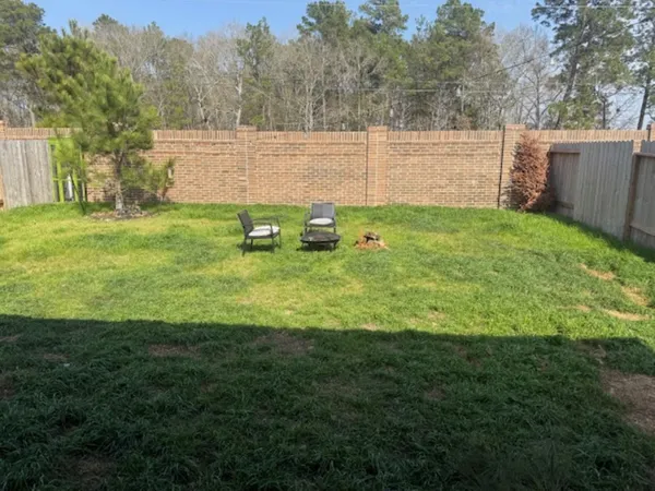 a view of a backyard with sitting area