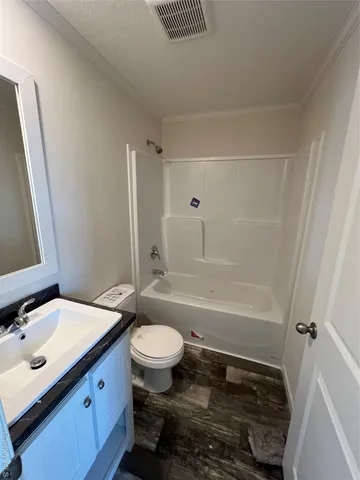 a bathroom with a sink toilet a mirror and shower