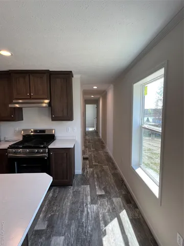 a kitchen with a stove a sink and a refrigerator