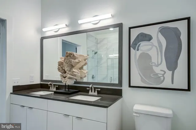a bathroom with a granite countertop sink and a mirror
