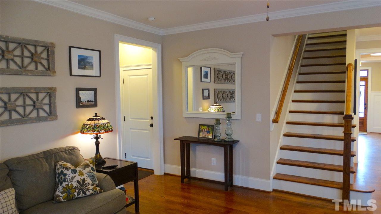 1308 Trinity Circle Raleigh, NC 27607 - Photo 2 of 25 The Family Room also leads up to the Beautifully Finished Hardwood Stairs with Wrought Iron Spindles.