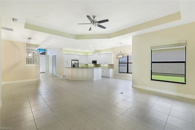 a view of a livingroom with furniture and ceiling fan