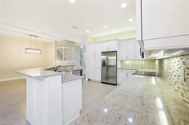 a kitchen with refrigerator and cabinets