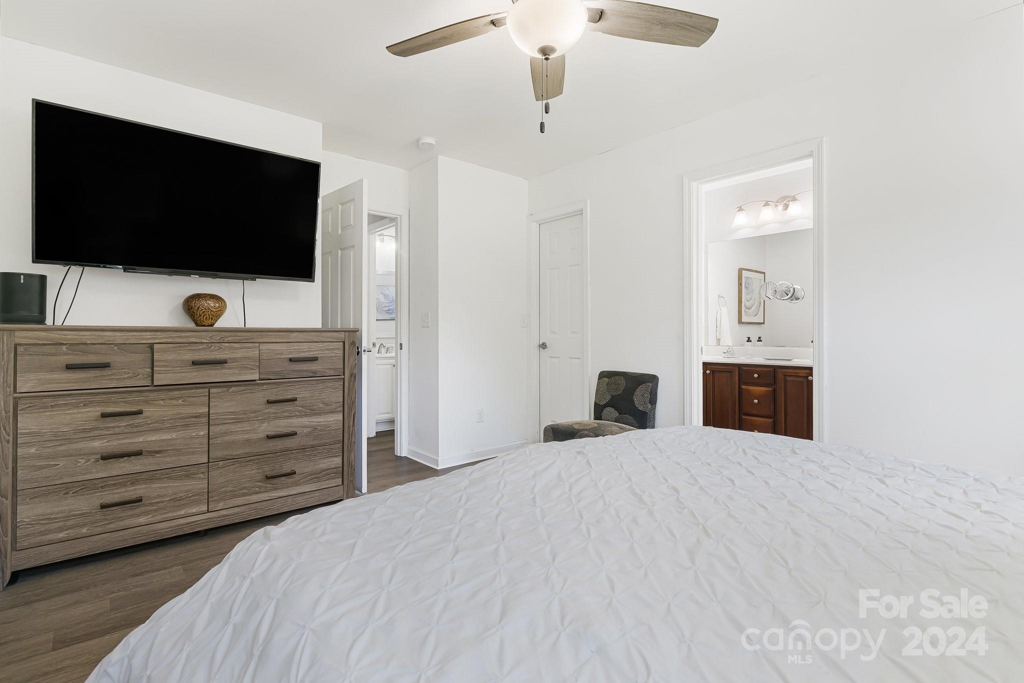 335 West Swift Creek Road Fletcher, NC 28732 - Photo 16 of 37 a bedroom with a bed and a flat screen tv