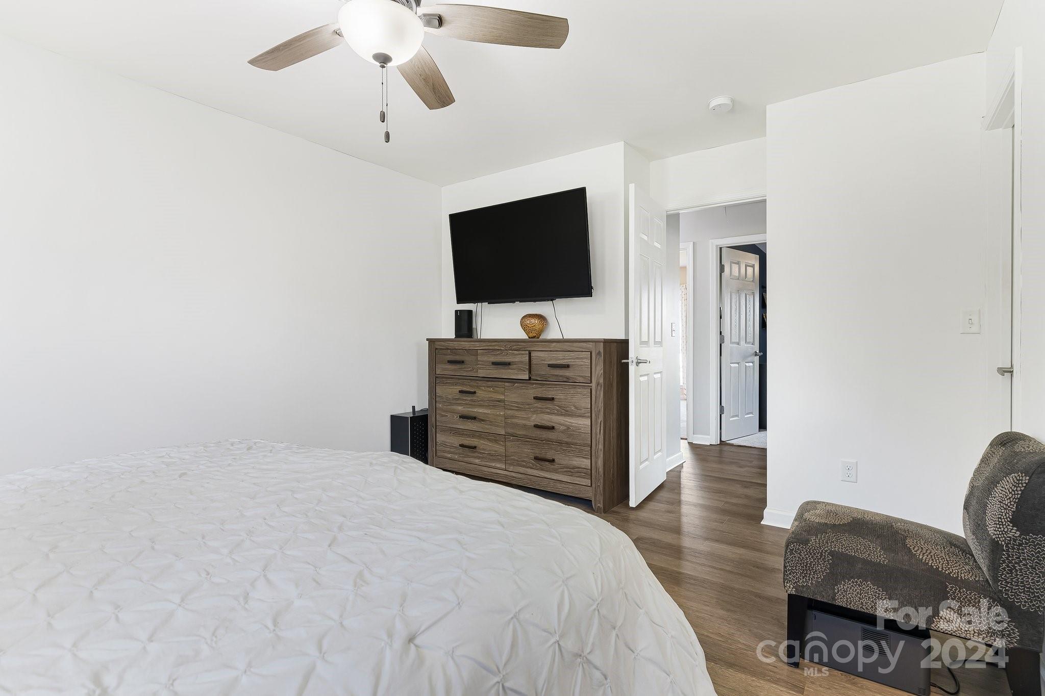 335 West Swift Creek Road Fletcher, NC 28732 - Photo 17 of 37 a bedroom with a bed and a flat screen tv