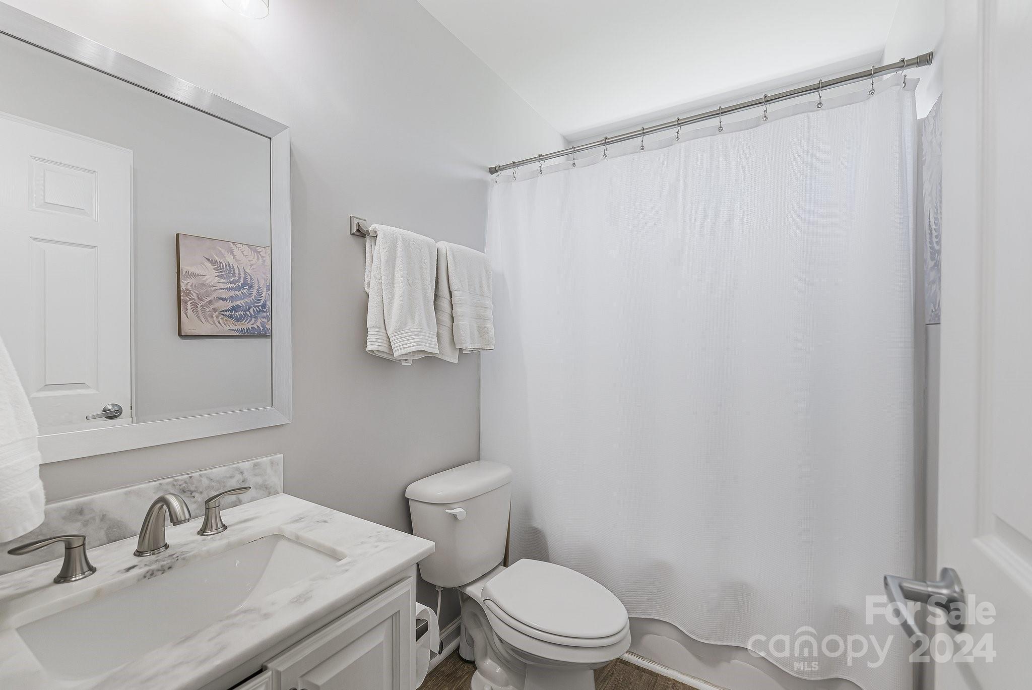 335 West Swift Creek Road Fletcher, NC 28732 - Photo 19 of 37 a bathroom with a sink toilet and shower