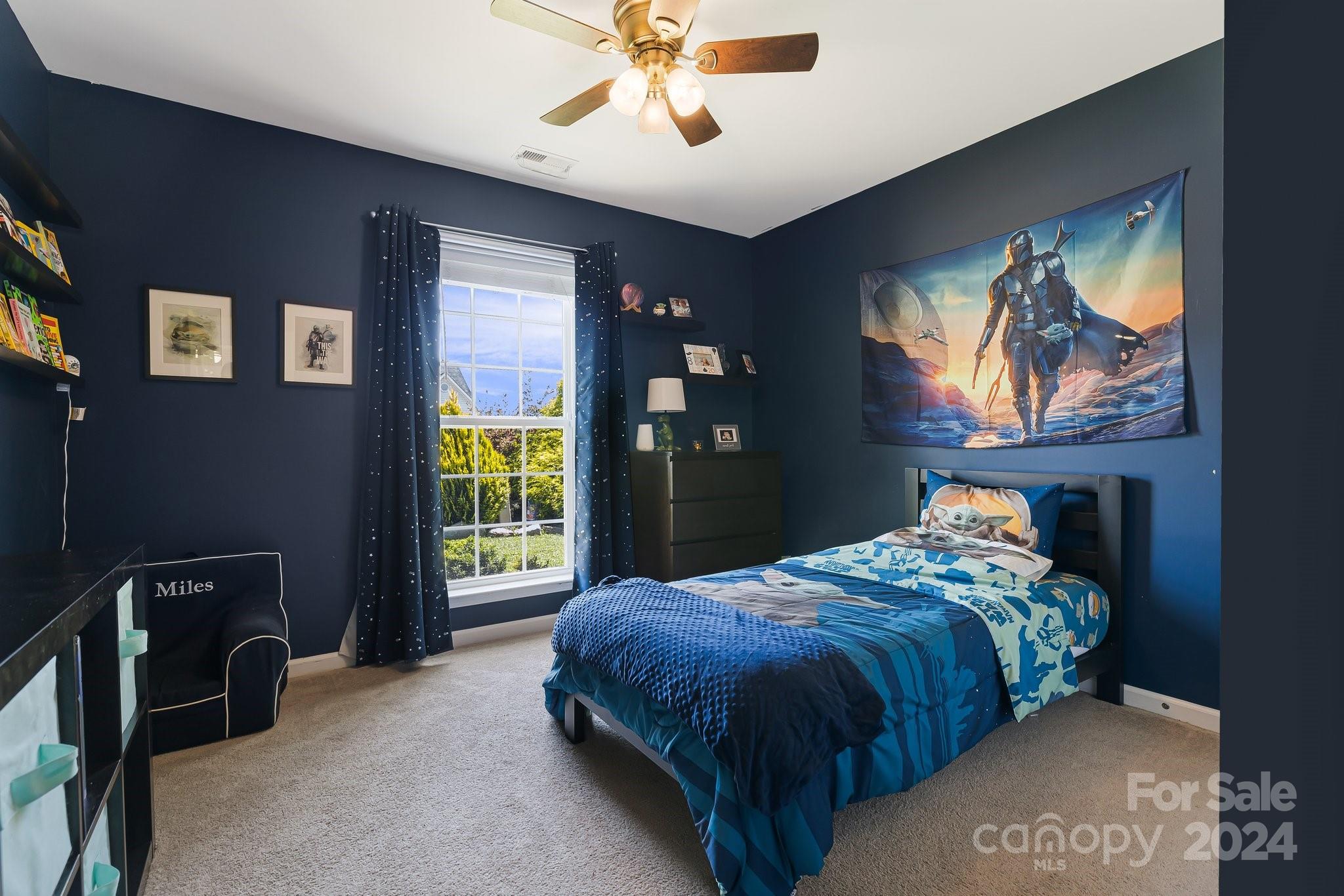 335 West Swift Creek Road Fletcher, NC 28732 - Photo 20 of 37 a bedroom with a bed and a chandelier