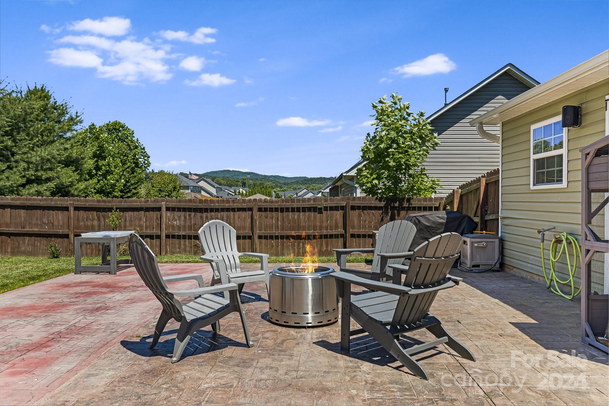 335 West Swift Creek Road Fletcher, NC 28732 - Photo 29 of 37 a view of a chairs and table in the back yard of the house