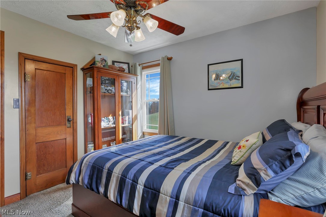5502 Dutch Ridge Road New Straitsville, OH 43766 - Photo 27 of 49 Bedroom with a ceiling fan and carpet