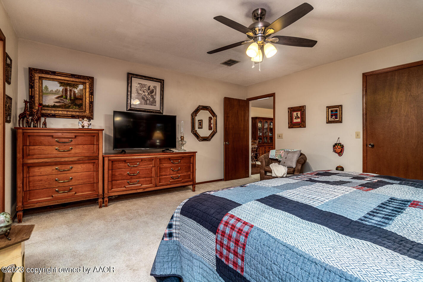 3406 Gladstone Lane Amarillo, TX 79121 - Photo 12 of 21 a bedroom with a bed a couch and a chandelier