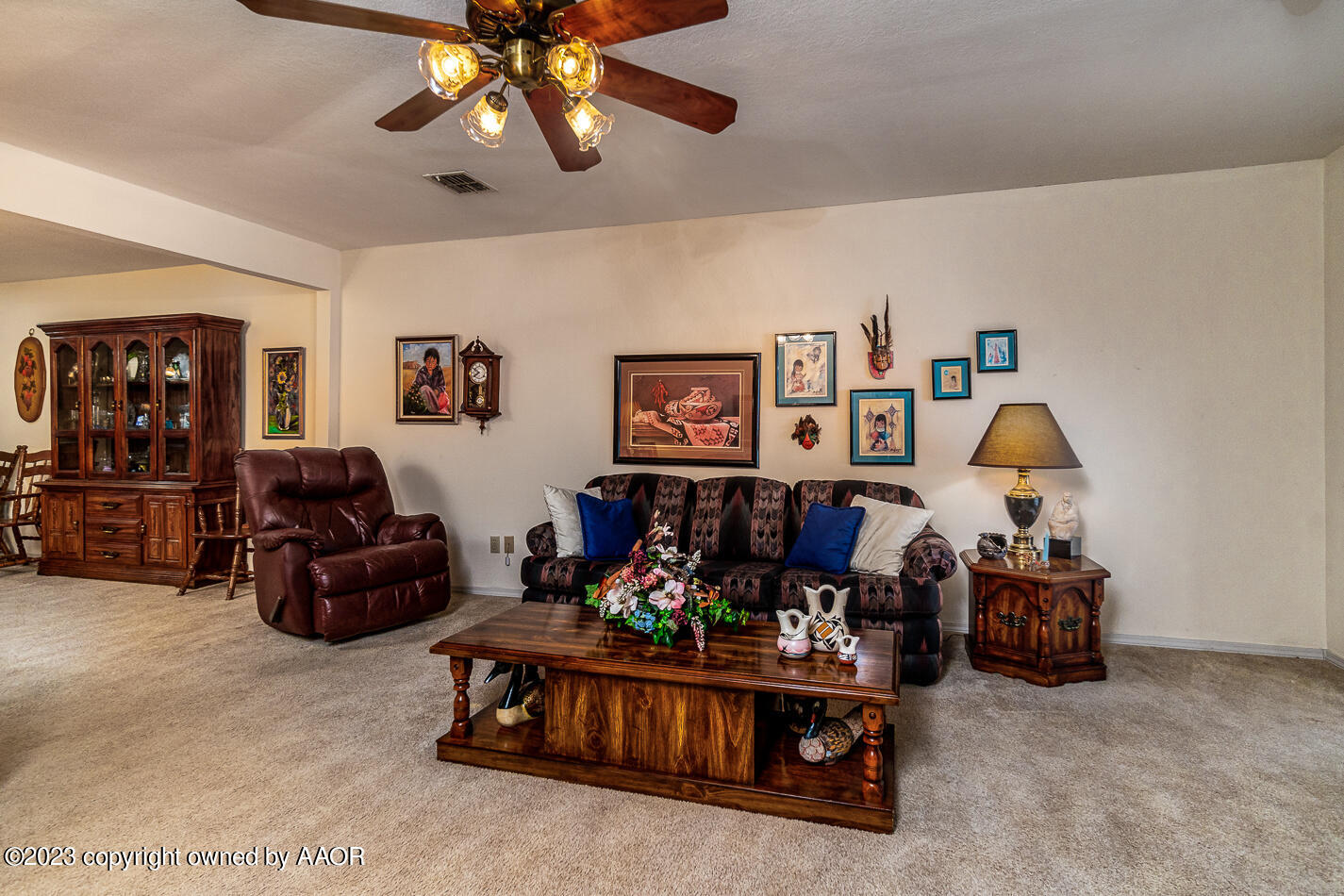 3406 Gladstone Lane Amarillo, TX 79121 - Photo 4 of 21 a living room with furniture and a chandelier
