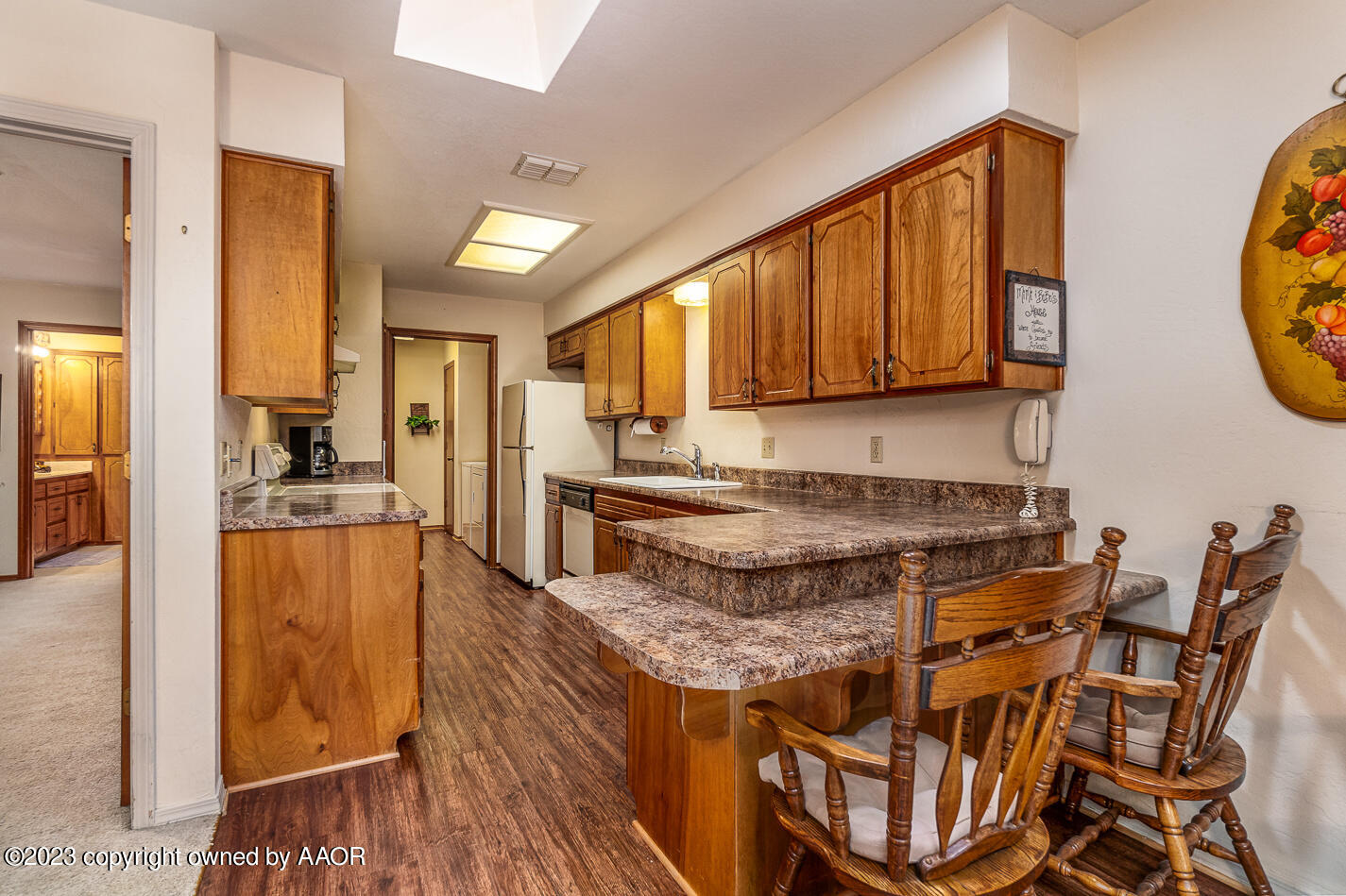 3406 Gladstone Lane Amarillo, TX 79121 - Photo 8 of 21 a kitchen with stainless steel appliances granite countertop wooden cabinets a stove a sink and a microwave