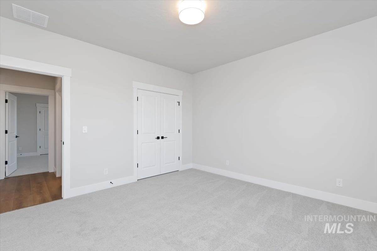 3321 Helios Street Caldwell, ID 83607 - Photo 25 of 35 Room featuring light gray carpet, white walls, and a semi-flush ceiling light