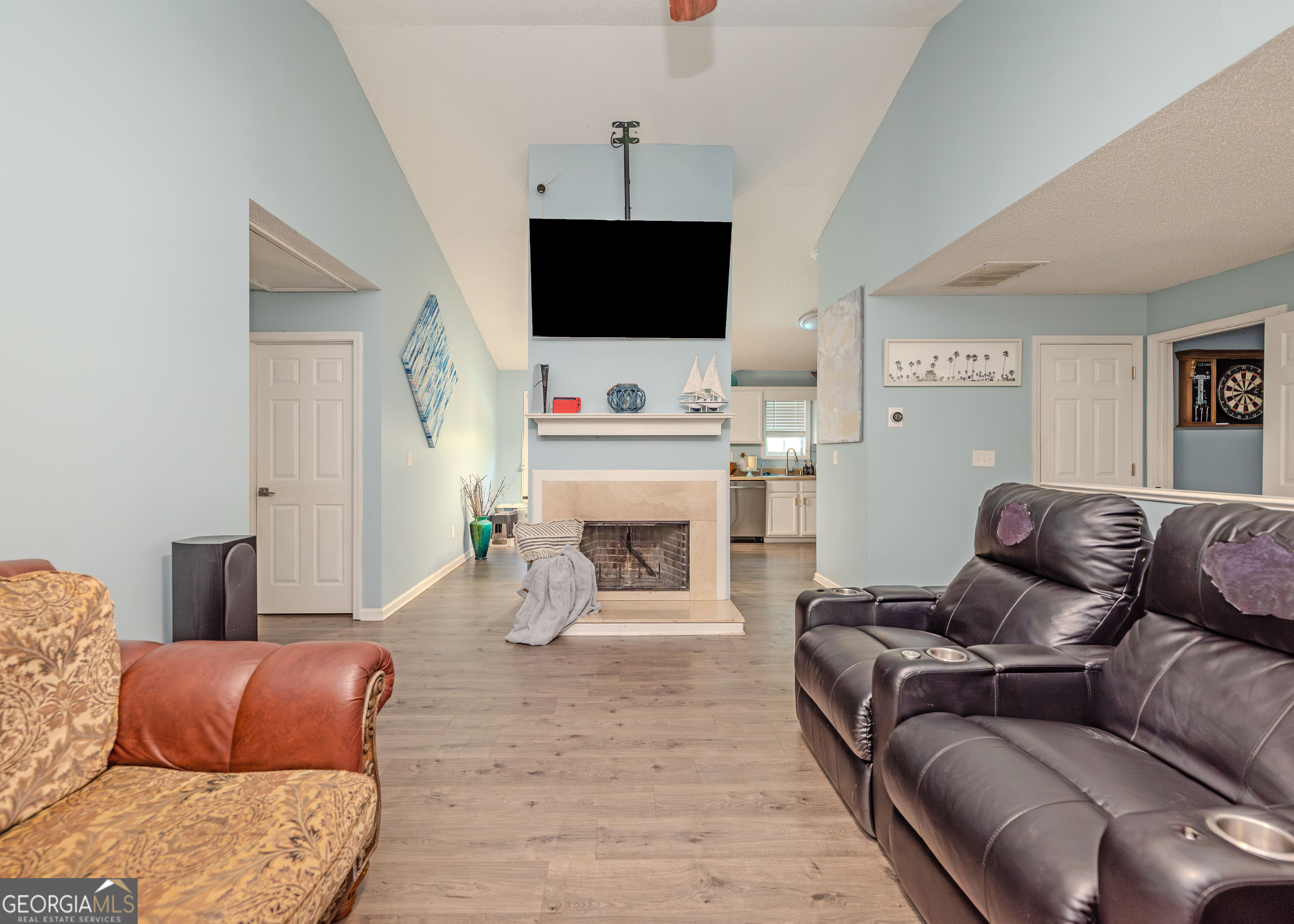 87 Little Milltown Road Hartwell, GA 30643 - Photo 11 of 39 a living room with furniture a flat screen tv and a fireplace