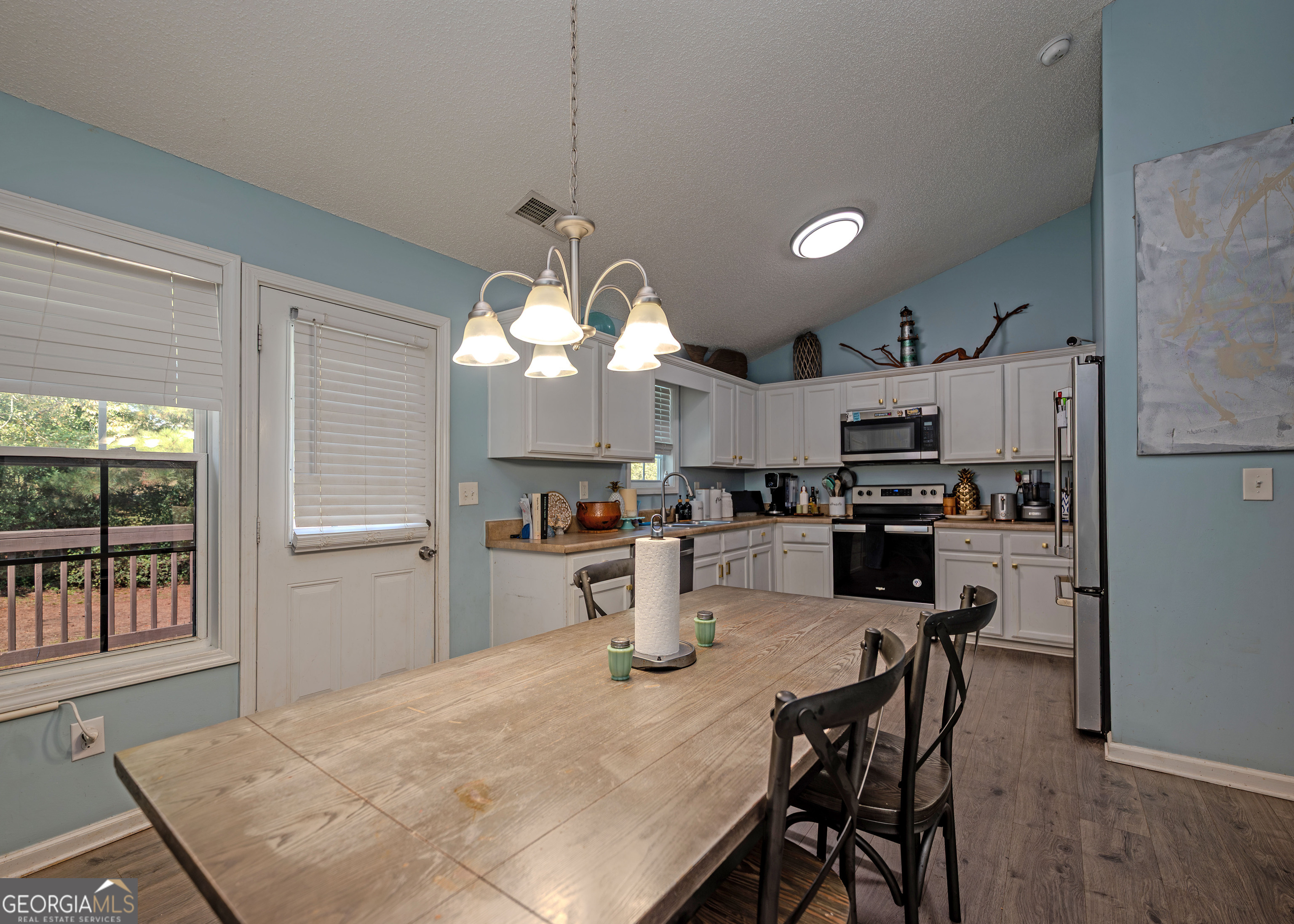 87 Little Milltown Road Hartwell, GA 30643 - Photo 12 of 39 a kitchen with sink a refrigerator and chairs