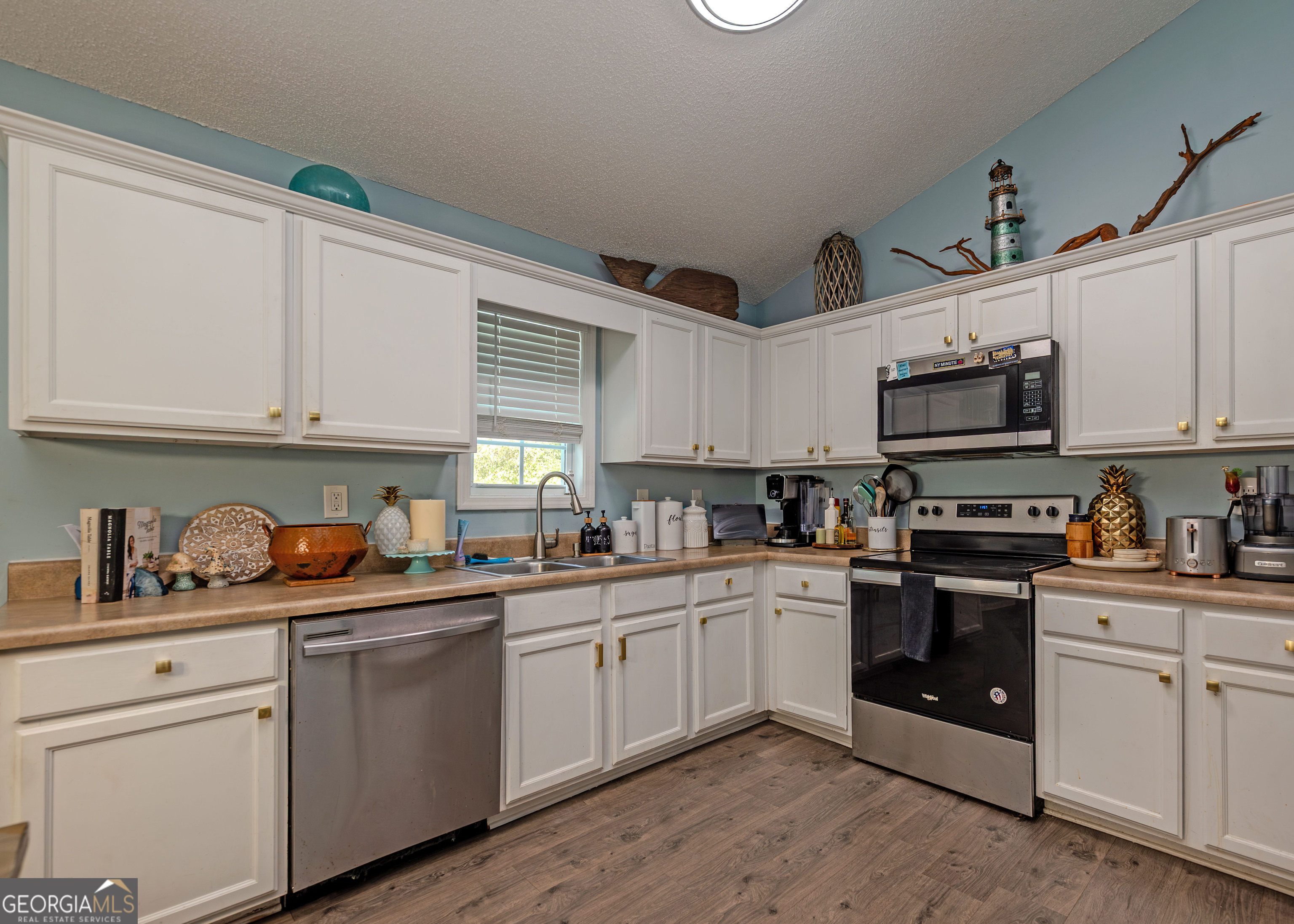 87 Little Milltown Road Hartwell, GA 30643 - Photo 13 of 39 a kitchen with stainless steel appliances granite countertop a sink a stove a microwave and cabinets