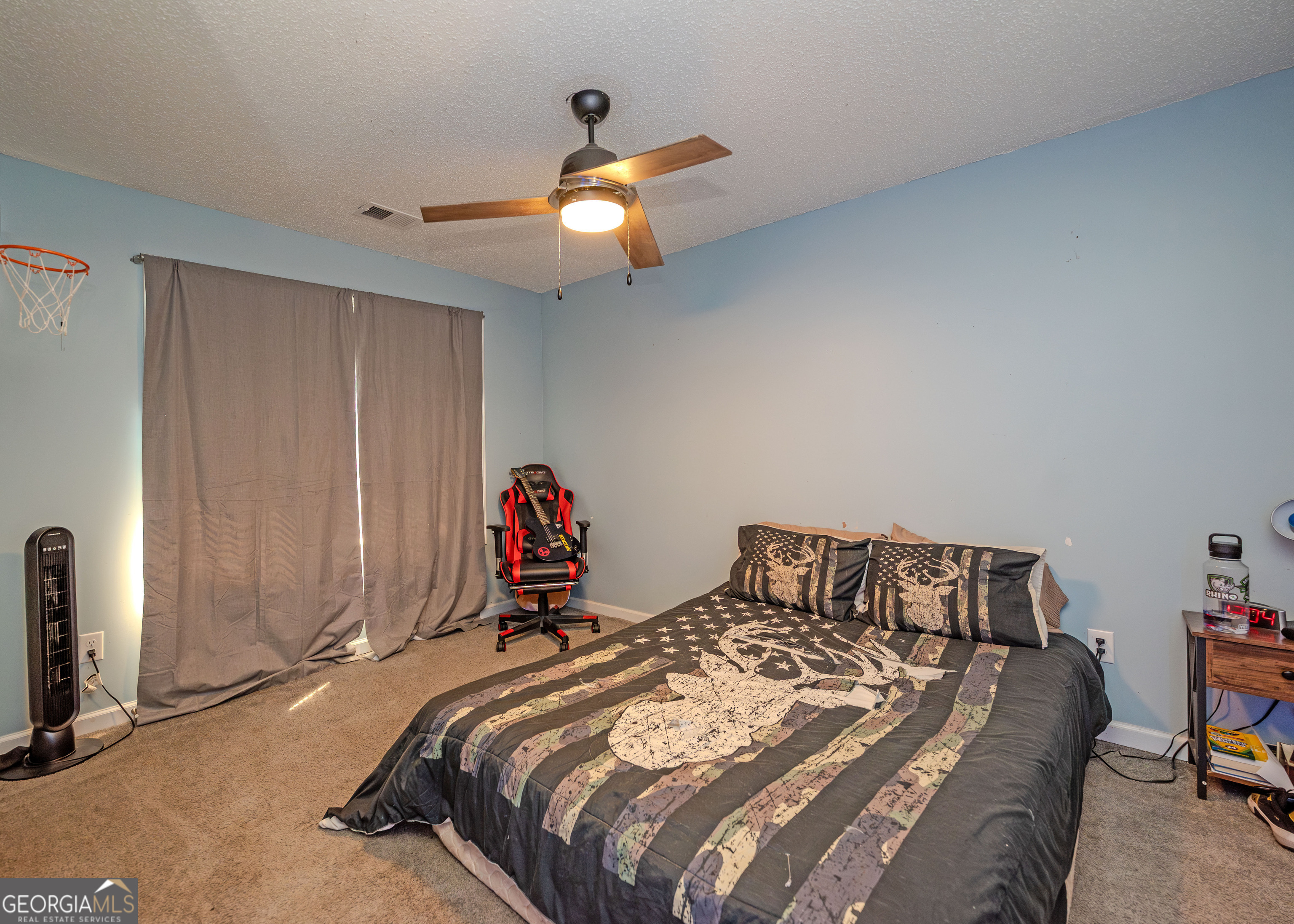 87 Little Milltown Road Hartwell, GA 30643 - Photo 18 of 39 a bedroom with a bed and a chandelier