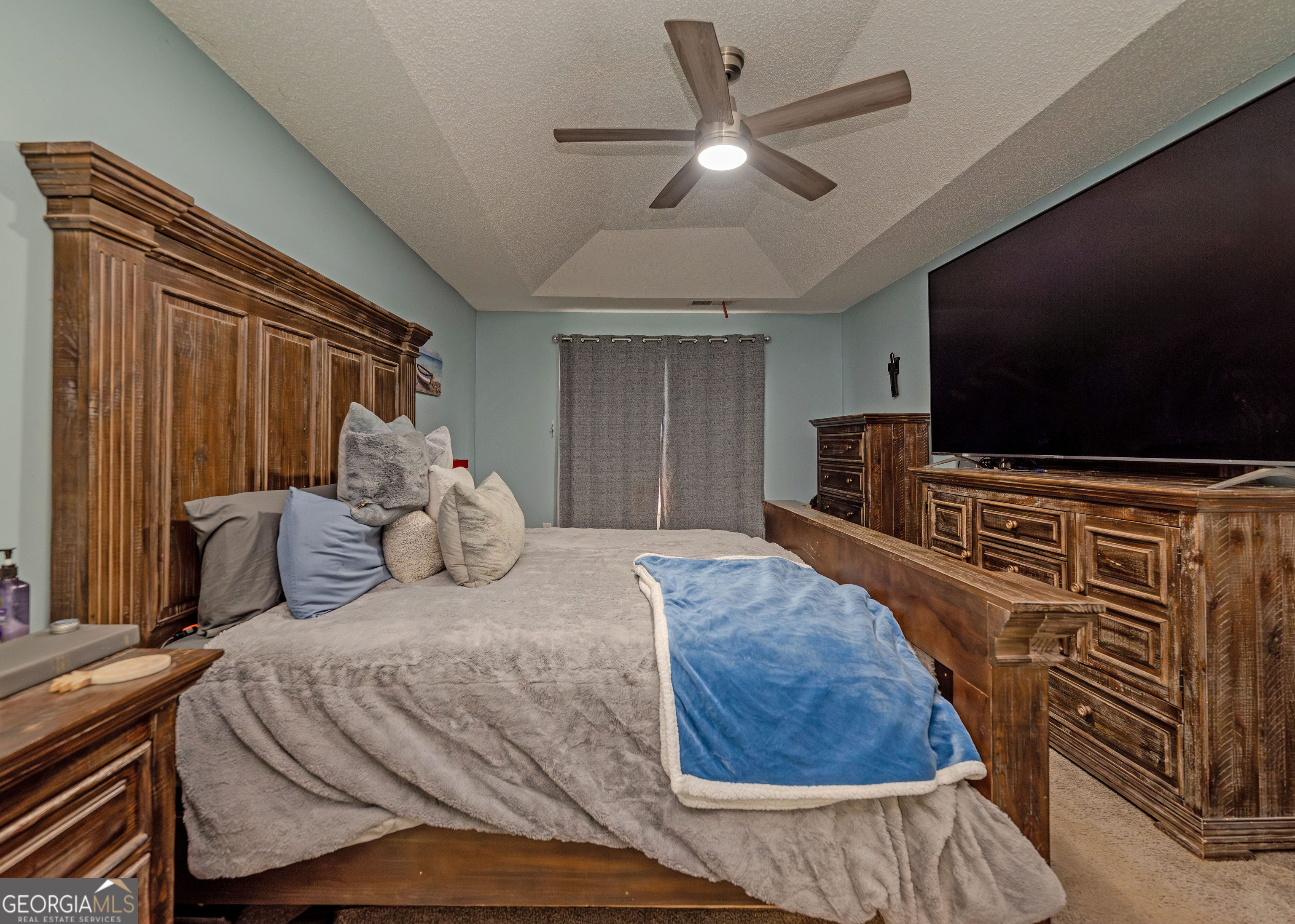 87 Little Milltown Road Hartwell, GA 30643 - Photo 21 of 39 a bedroom with a large bed and a flat screen tv