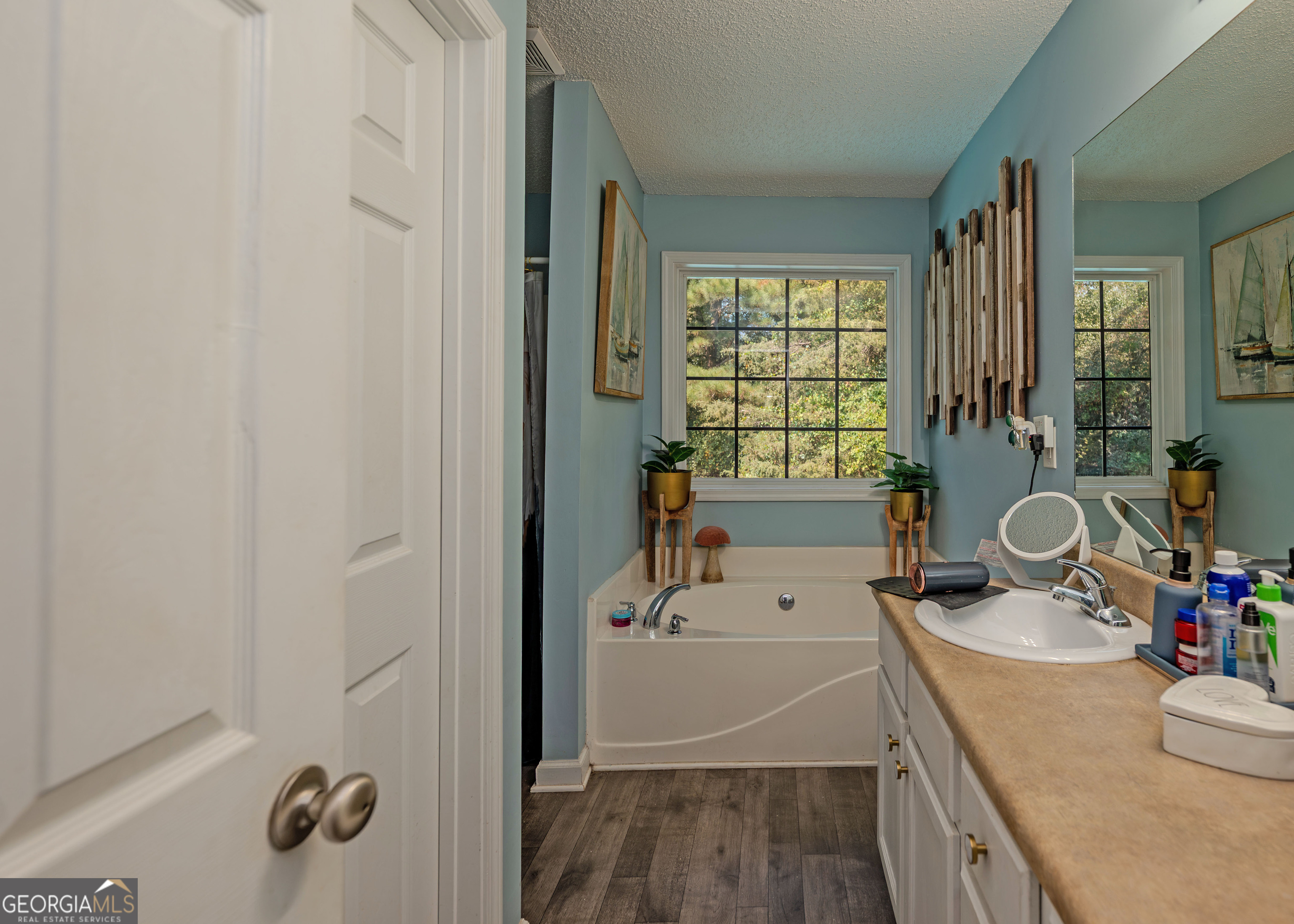 87 Little Milltown Road Hartwell, GA 30643 - Photo 22 of 39 a bathroom with a granite countertop sink a mirror and shower