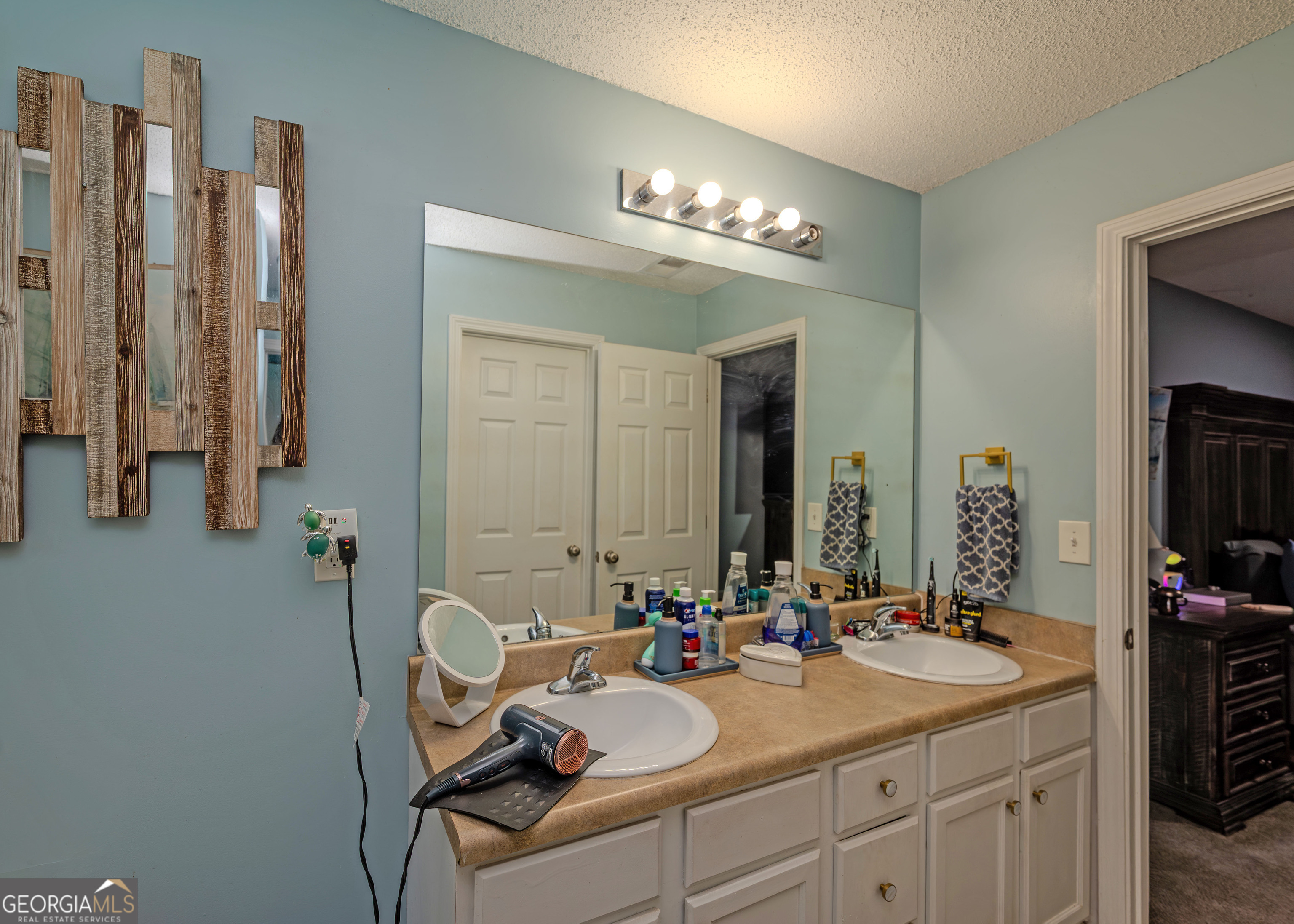 87 Little Milltown Road Hartwell, GA 30643 - Photo 23 of 39 a bathroom with a double vanity sink and a mirror